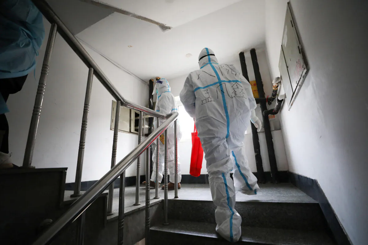 Medical workers prepare to conduct nucleic acid tests for the Covid-19 coronavirus on residents who can't leave their premises in Shenyang, Liaoning Province, on March 23, 2022. (STR/AFP via Getty Images)