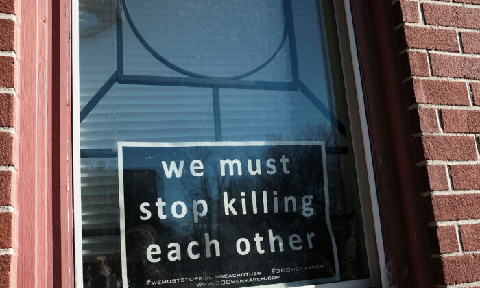 A sign to end violence sits in a window in a neighborhood with a high murder rate in Baltimore, Md., on Feb. 3, 2018.  (Spencer Platt/Getty Images)