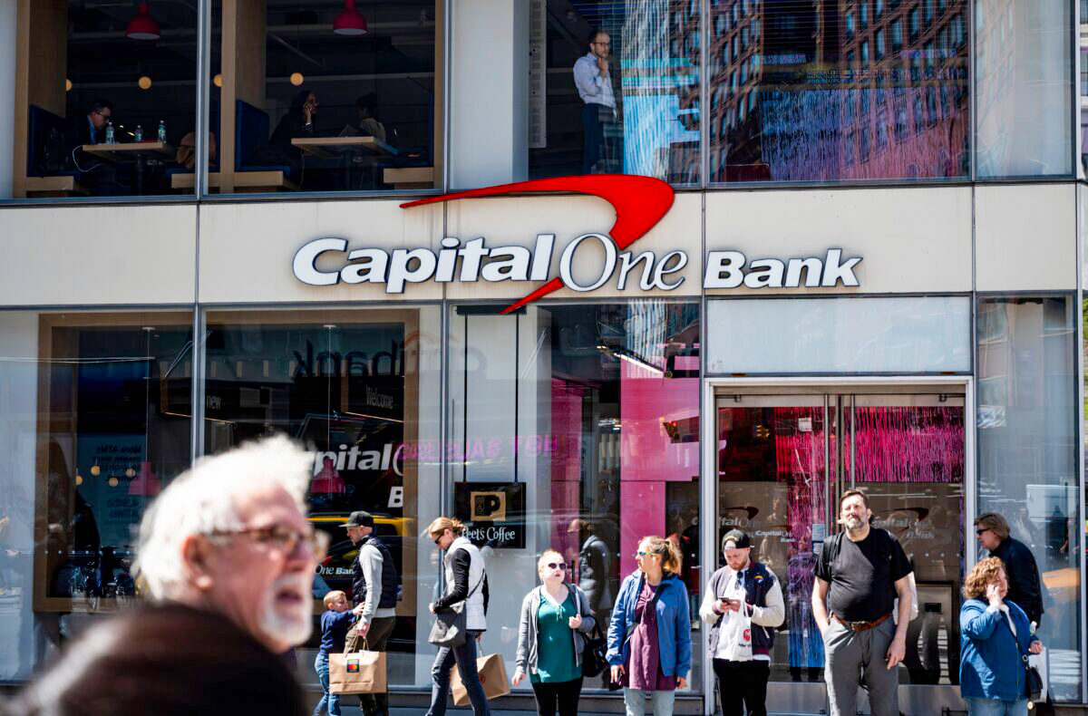 People walk past a branch of the Capital One Bank in New York on April 17, 2019. (Johannes Eisele/AFP via Getty Images)