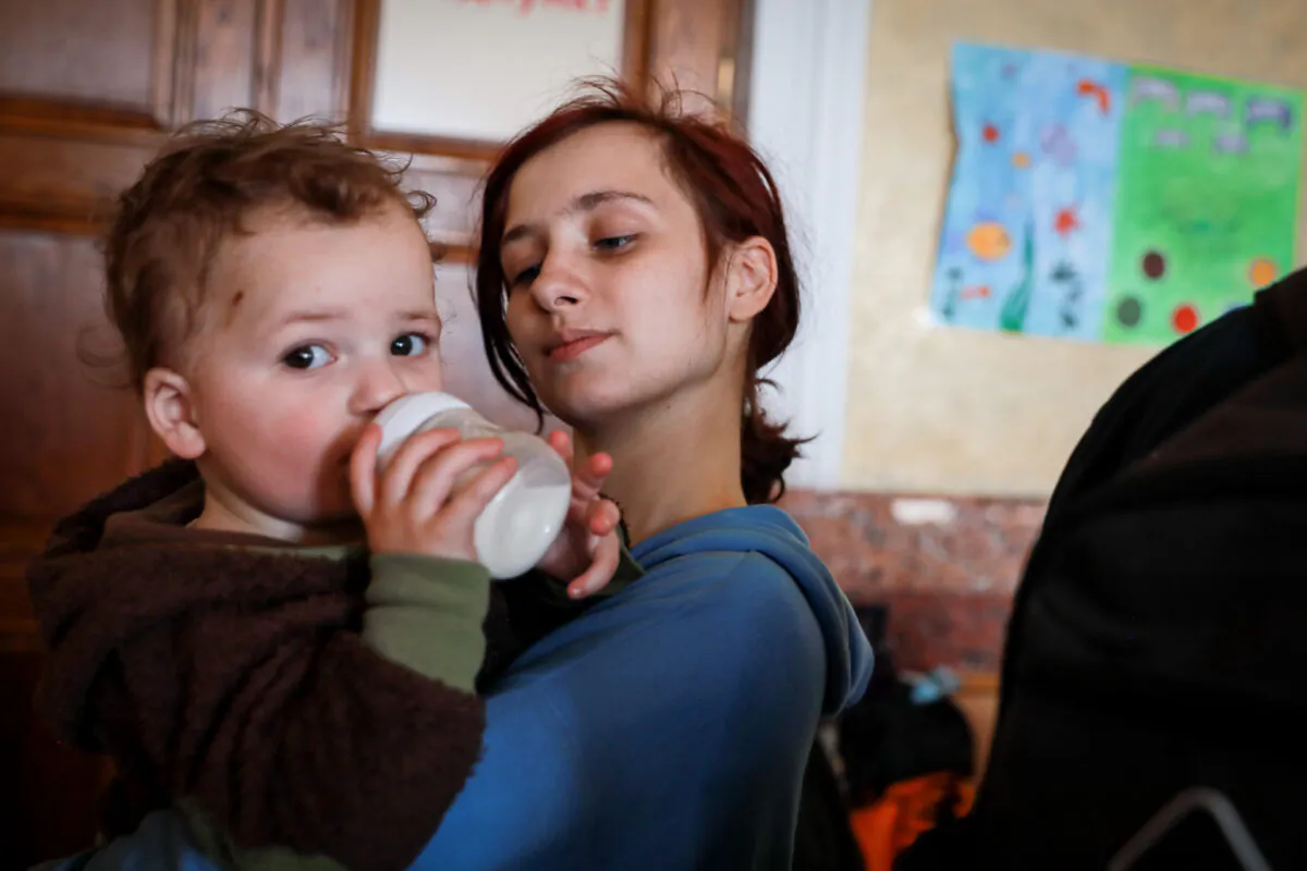Alina Kaconskaya with her baby Denis at the Lviv train station in Lviv, Ukraine, on March 24, 2022. (Charlotte Cuthbertson/The Epoch Times)