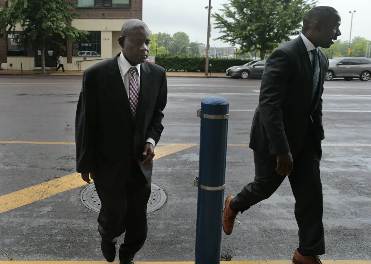 Former FBI agent William Don Tisaby, left, is accompanied by attorney Jermaine Wooten as he turns himself in at St. Louis Police headquarters on June 17, 2019. (Robert Cohen/St. Louis Post-Dispatch via AP)
