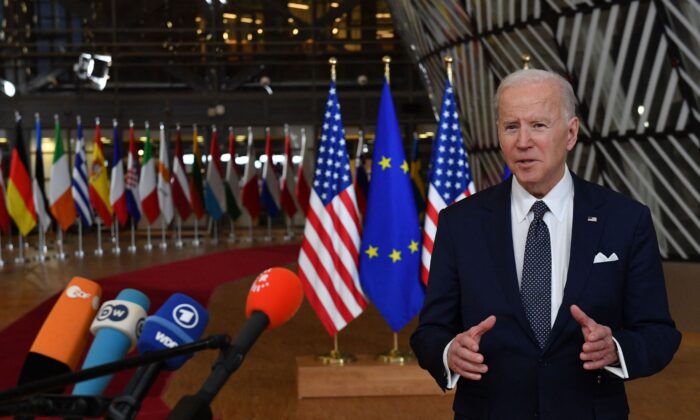 President Joe Biden addresses media representatives as he arrives for a European Union (EU) summit at EU Headquarters in Brussels, on March 24, 2022. (John Thys/AFP via Getty Images)