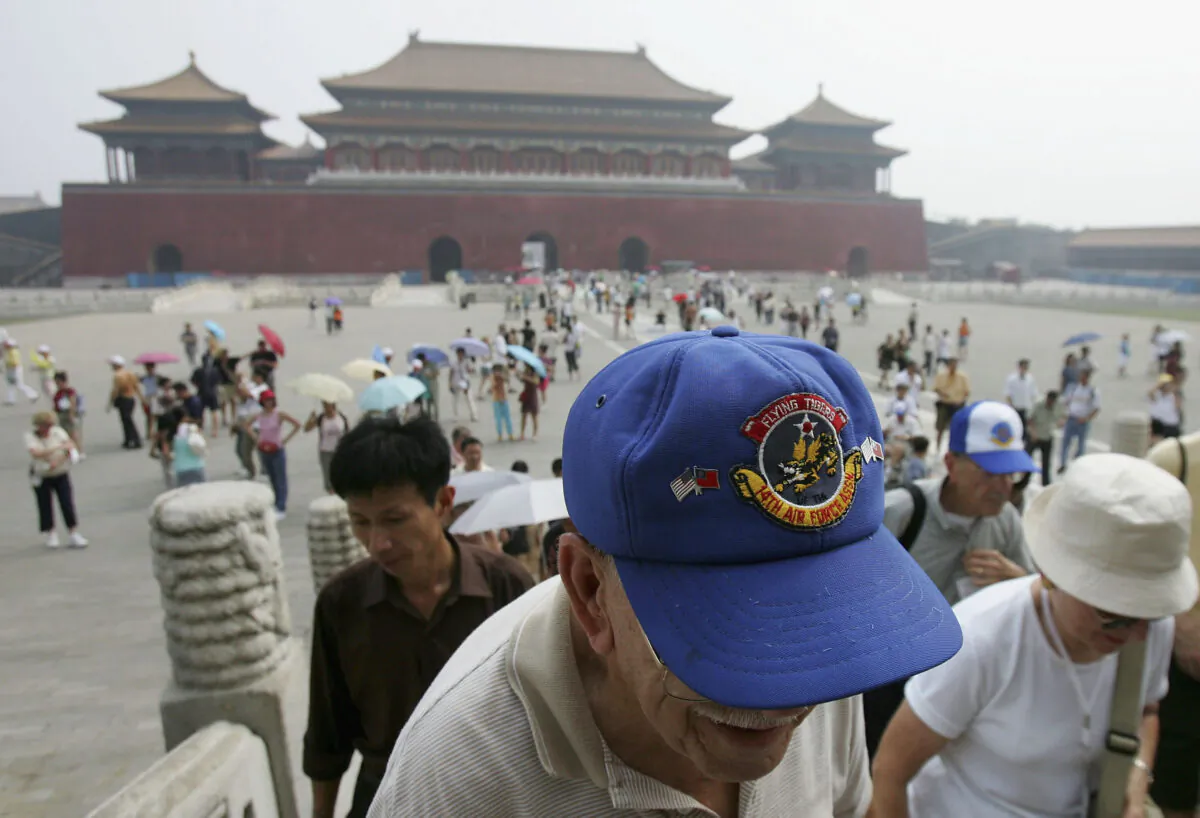 Retired U.S. Air Force pilots who carried out missions in China during World War II visit the Forbidden City in Beijing, China, on Aug. 14, 2005. A group of 270 World War II veterans from the U.S. who had supported the Chinese army to fight against the Japanese invasion, including members of the American Volunteer Group Flying Tigers, are visiting China to attend events celebrating the anniversary of the Anti-Fascist War victory. (China Photos/Getty Images)