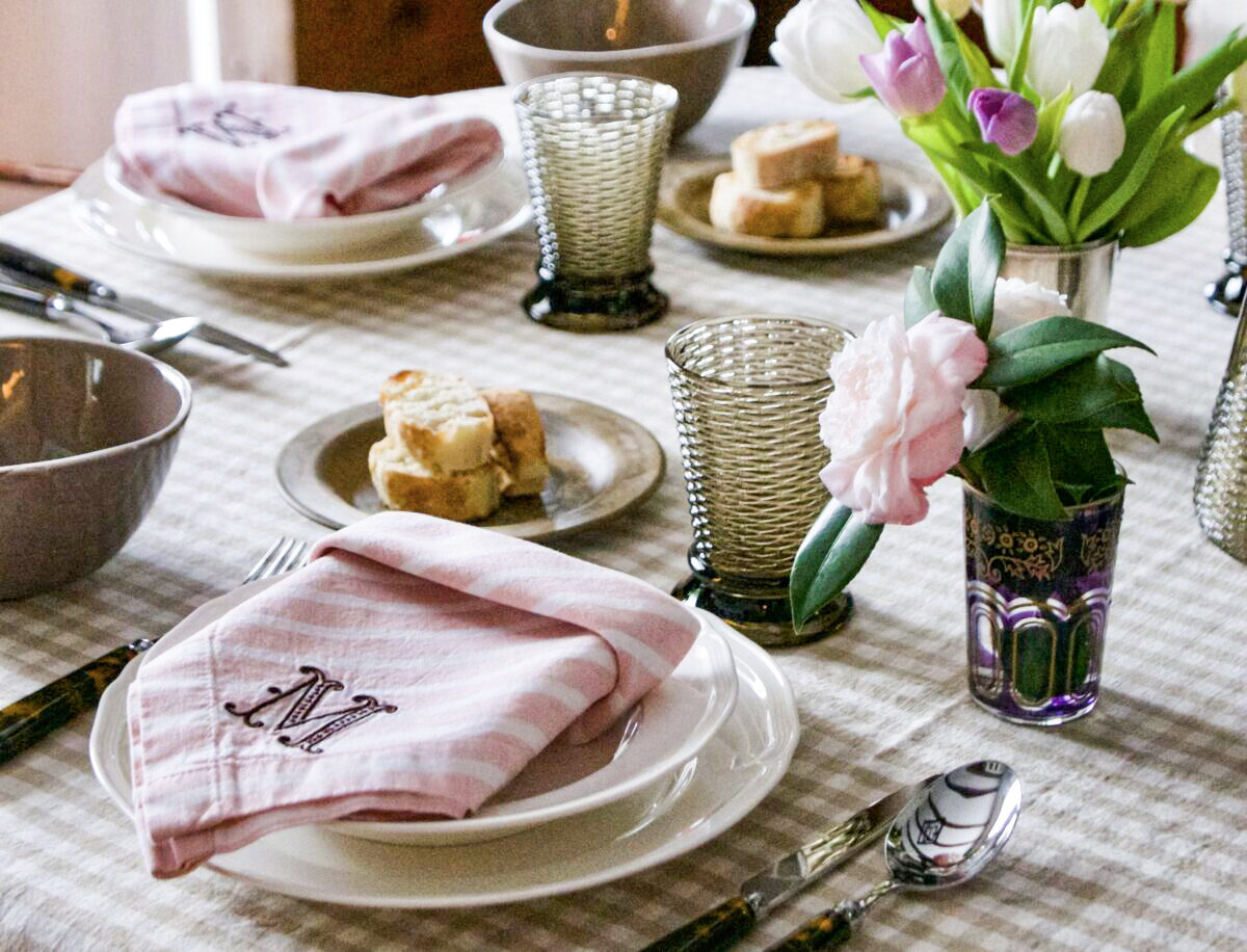 Flowers and candles make an ordinary family dinner feel special. Have your children help you set the table—and let them choose the colors! (Victoria de la Maza)