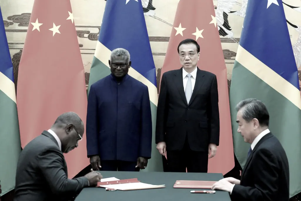 (L-R) Former Solomon Islands Prime Minister Manasseh Sogavare, Solomon Islands Foreign Minister Jeremiah Manele, Chinese Premier Li Keqiang and Chinese State Councillor and Foreign Minister Wang Yi attend a signing ceremony at the Great Hall of the People in Beijing, China, on Oct. 9, 2019. (Thomas Peter-Pool/Getty Images)