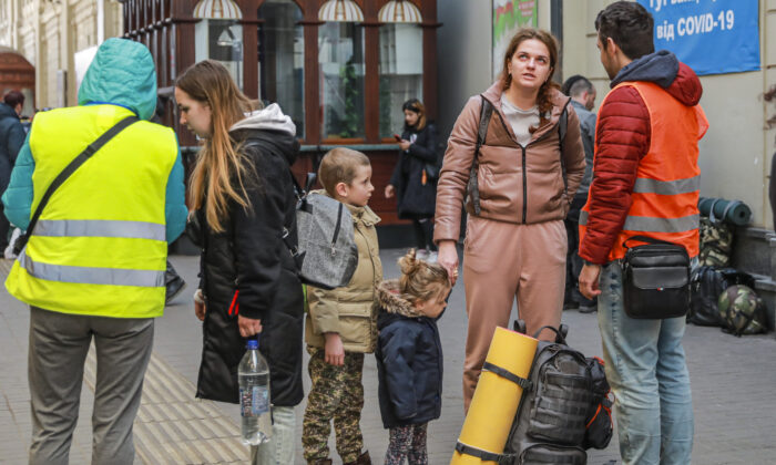 Ukrainians who are fleeing war-torn eastern cities arrive at the Lviv train station for onward travel, in Lviv, Ukraine, on March 24, 2022. (Charlotte Cuthbertson/The Epoch Times)