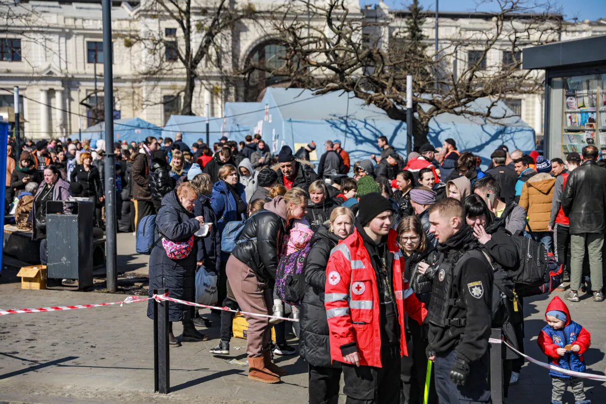 Ukrainians who are fleeing war-torn eastern cities wait at the Lviv train station for onward travel, in Lviv, Ukraine, on March 24, 2022. (Charlotte Cuthbertson/The Epoch Times)