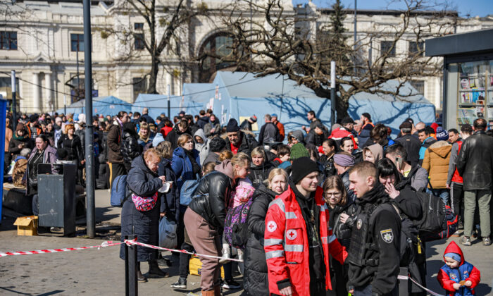 Ukrainians who are fleeing war-torn eastern cities wait at the Lviv train station for onward travel, in Lviv, Ukraine, on March 24, 2022. (Charlotte Cuthbertson/The Epoch Times)
