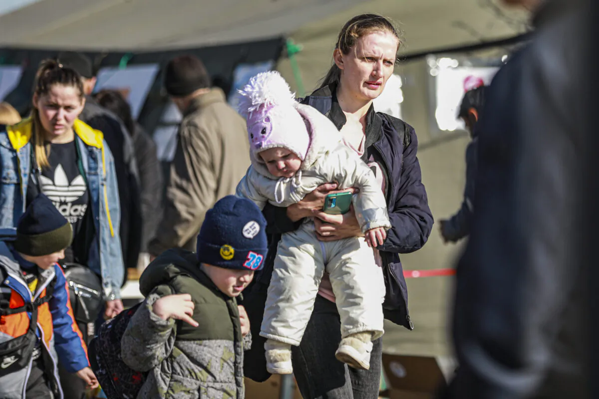 Ukrainians who are fleeing war-torn eastern cities arrive at the Lviv train station for onward travel, in Lviv, Ukraine, on March 24, 2022. (Charlotte Cuthbertson/The Epoch Times)