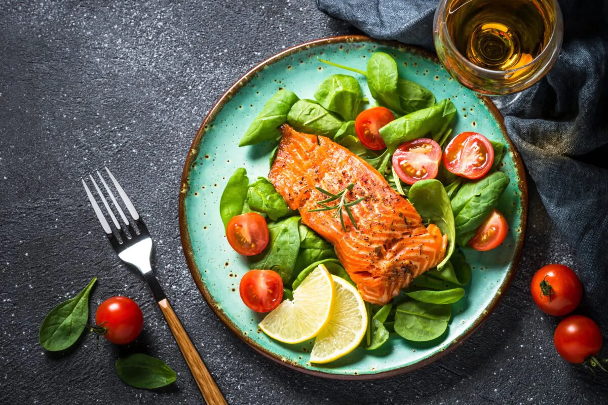 Salmon and spinach with cherry tomatoes makes a delicious keto meal. (nadianb/Shutterstock)