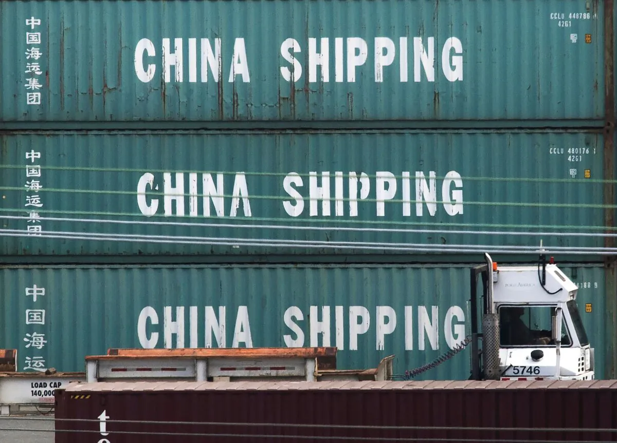 A truck passes by China Shipping containers at the Port of Los Angeles, in Long Beach, Calif., on Sept. 1, 2019. (Mark Ralston/AFP via Getty Images)