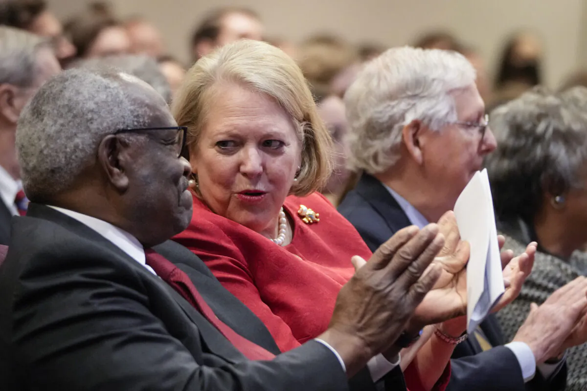 Associate Supreme Court Justice Clarence Thomas sits with his wife and conservative activist Virginia Thomas while he waits to speak at the Heritage Foundation in Washington, on Oct. 21, 2021. (Drew Angerer/Getty Images)