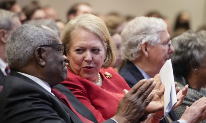 Associate Supreme Court Justice Clarence Thomas sits with his wife and conservative activist Virginia Thomas while he waits to speak at the Heritage Foundation in Washington, D.C., on Oct. 21, 2021. (Drew Angerer/Getty Images)
