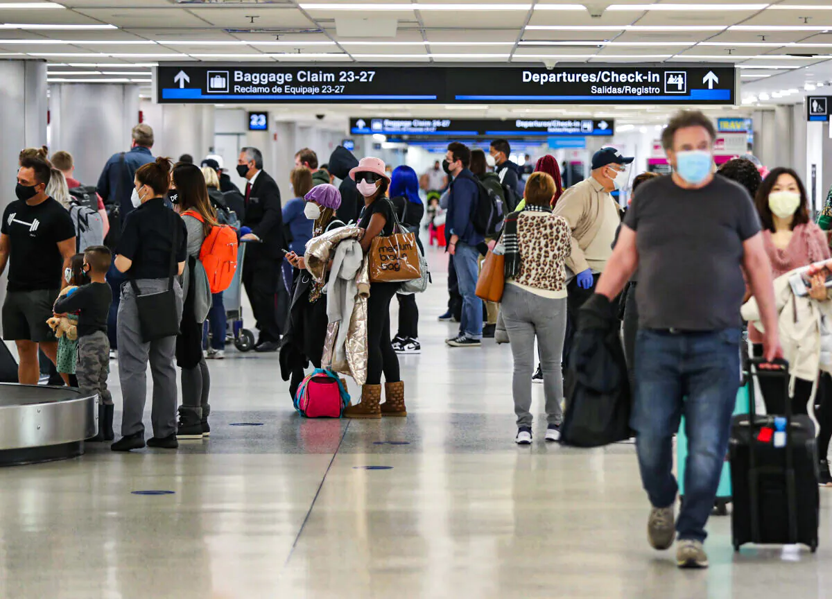People gather their luggage after arriving at Miami International Airport on a plane from New York on Feb. 1, 2021, in Miami, Fla. (Joe Raedle/Getty Images)