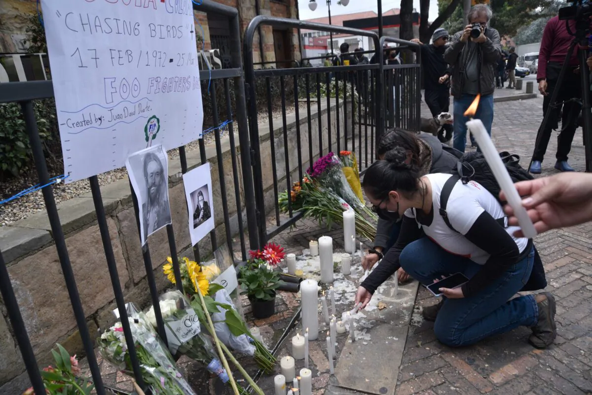Fans of U.S. band Foo Fighters place lit candles outside Casa Medina Hotel where the band's drummer Taylor Hawkins was found dead, in Bogota, Colombia, on March 26, 2022. (Guillermo Legaria/Getty Images)