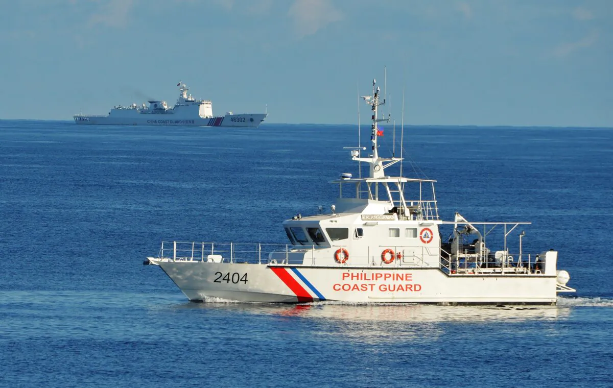 A Philippine coast guard ship sails past a Chinese coastguard ship during an joint search and rescue exercise near Scarborough shoal in the South China Sea on May 14, 2019. (Ted Aljibe/AFP via Getty Images)