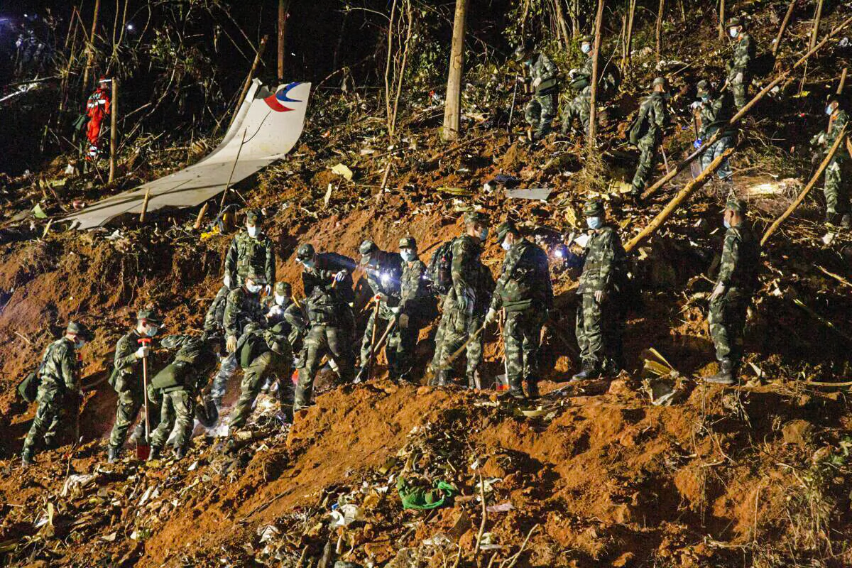Rescuers work at the site of a plane crash in Tengxian county, Wuzhou city of Guangxi region, China, on March 22, 2022. A China Eastern Airlines Boeing 737-800NG aircraft carrying 132 people, including 123 passengers and nine crew members, crashed in South China's Guangxi region on March 21. (VCG via Getty Images)