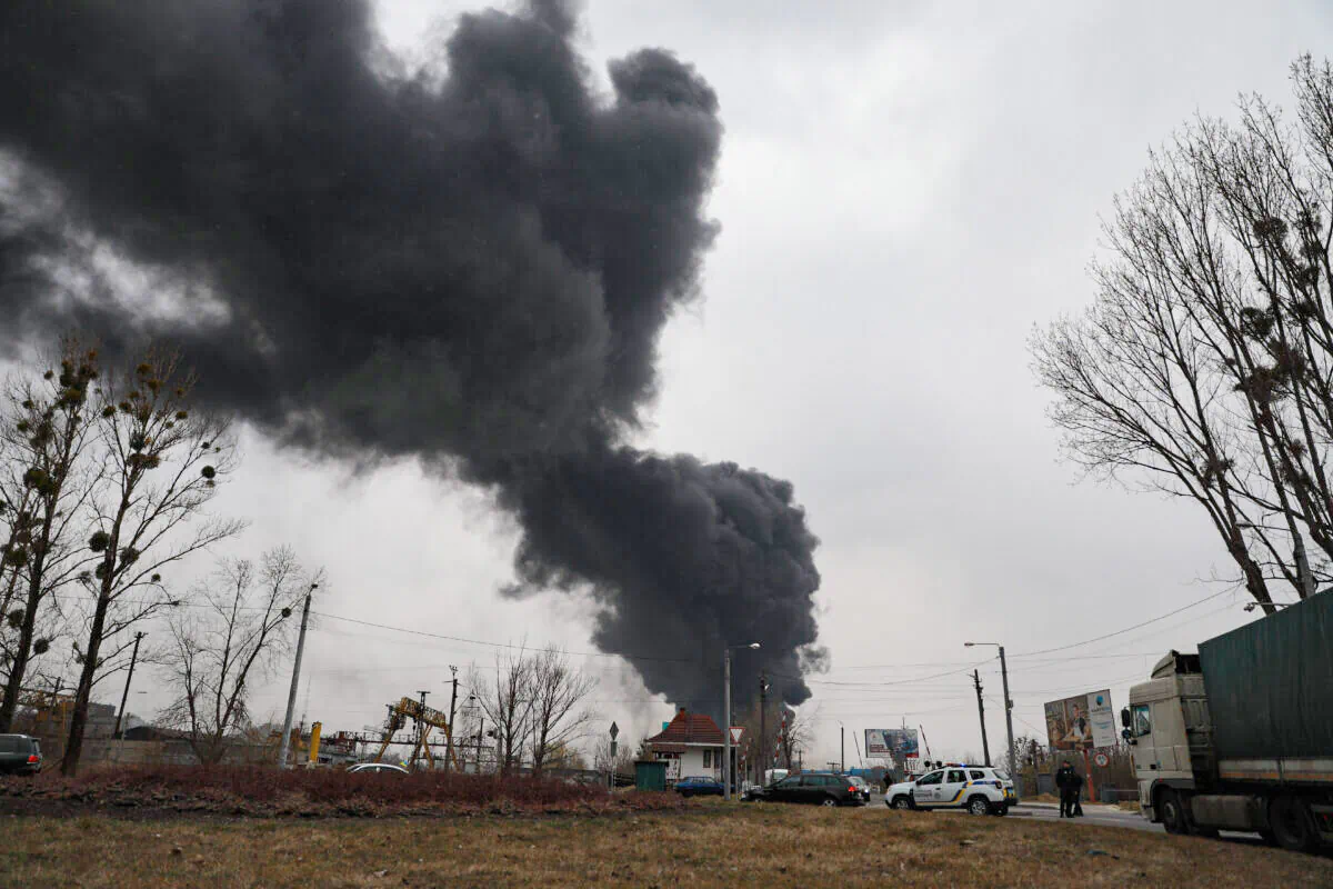 Black smoke billows after authorities said a missile attack hit an industrial area of Lviv, Ukraine, on March 26, 2022. (Charlotte Cuthbertson/The Epoch Times)