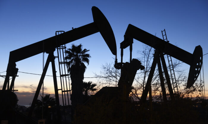 An oil pumpjack (L) operates as another (R) stands idle in the Inglewood Oil Field in Los Angeles, Calif., on Jan. 28, 2022. (Mario Tama/Getty Images)