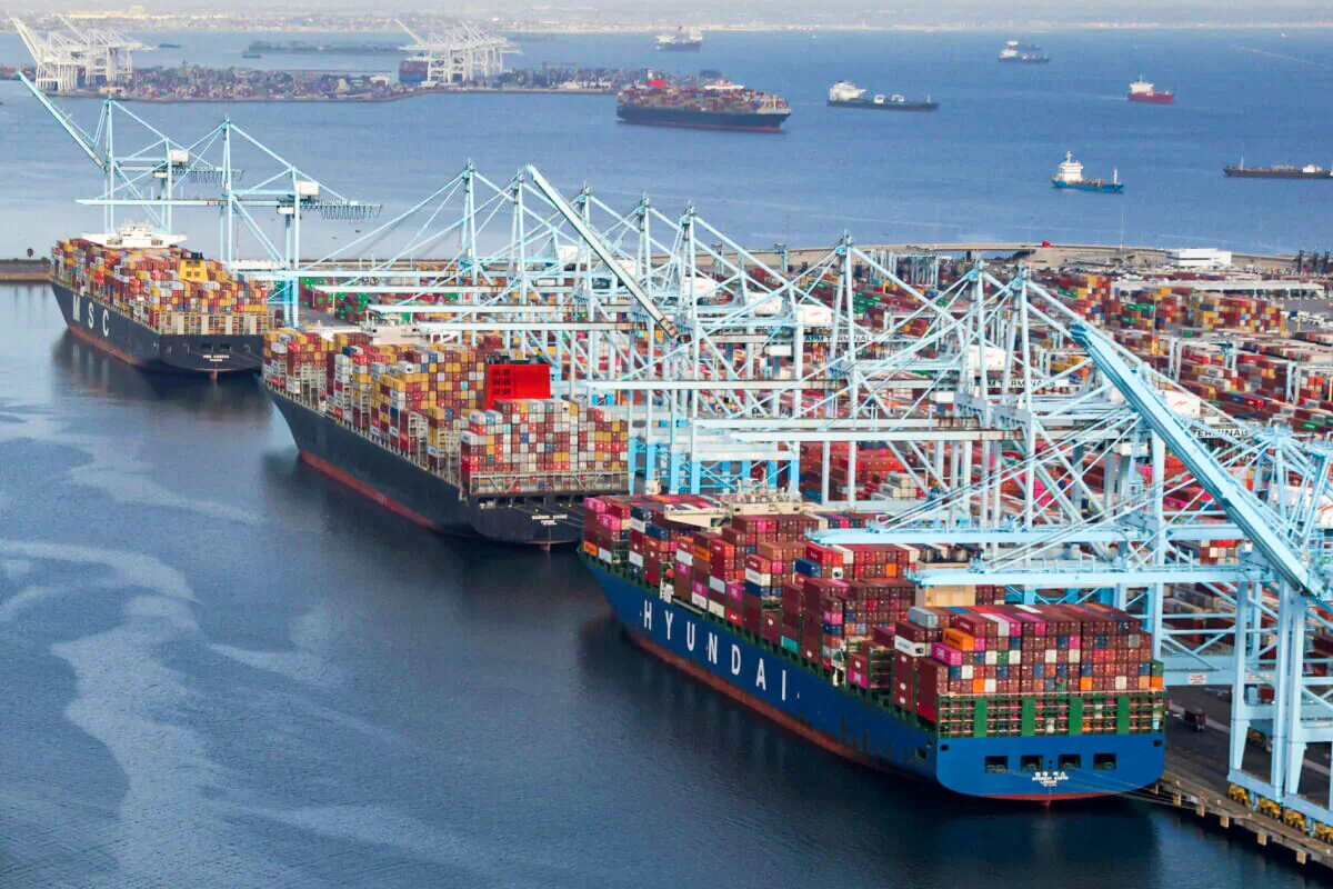 Shipping containers are unloaded from ships at a container terminal at the Port of Long Beach-Port of Los Angeles complex in Los Angeles, Calif., on April 7, 2021. (Lucy Nicholson/Reuters)