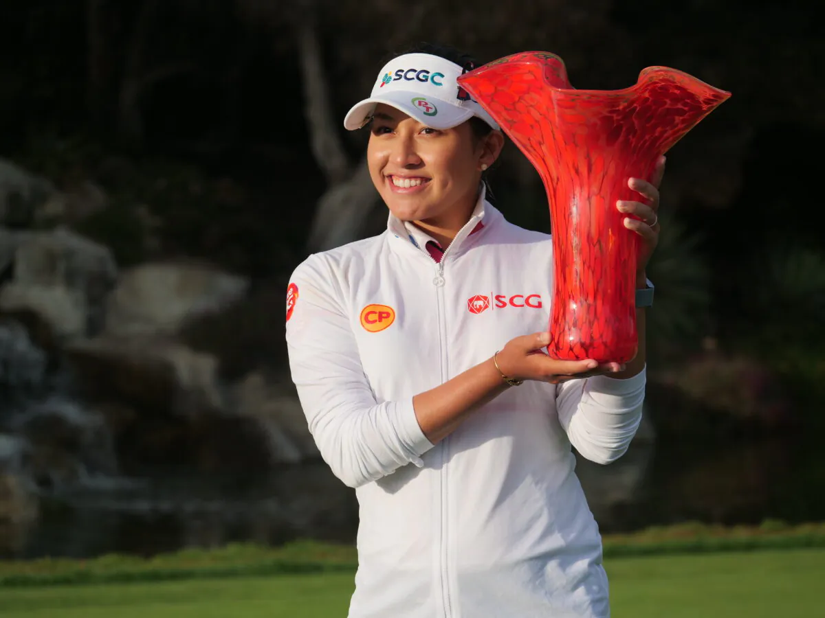 Atthaya Thitikul of Thailand holds the winner's trophy after her playoff victory over Nana Koerstz Madsen of Denmark during the final round of the JTBC Classic at Aviara Golf Club, in Carlsbad, Calif., on March 27, 2022. (Nhat Hoang/The Epoch Times)