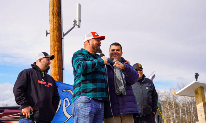 (L to R) The People’s Convoy co-organizer Mike Landis, co-organizer Brian Brase, the Unity Project’s Chief Scientific Officer Dr. Paul Alexander, and emcee Marcus Summers at a rally at Hagerstown Speedway in Hagerstown, Md., on Mar. 26, 2022. (Terri Wu/The Epoch Times)