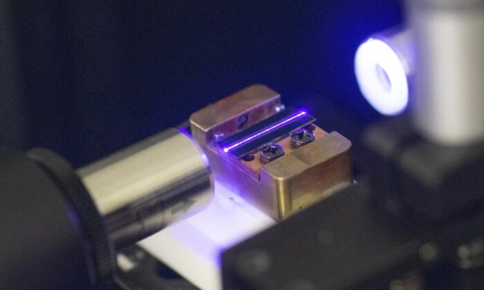 A laser tests the optical waveguide of a chip for quantum computing in a laboratory in Stuttgart, southern Germany, on Sept. 14, 2021. (Thomas Kienzle/AFP via Getty Images) 