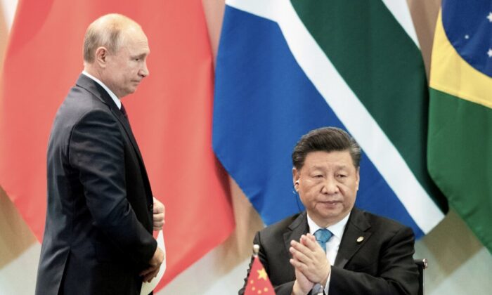 Chinese leader Xi Jinping and Russian President Vladimir Putin attend a meeting with members of the Business Council and management of the New Development Bank during the BRICS Summit in Brasilia on Nov. 14, 2019. (Pavel Golovkin/Pool/AFP via Getty Images)
