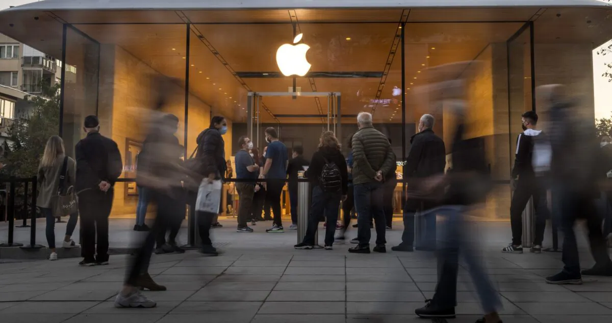People wait outside the entrance to an Apple retail store after its opening on Bagdat Caddesi in Istanbul, on Oct. 22, 2021. (Chris McGrath/Getty Images)