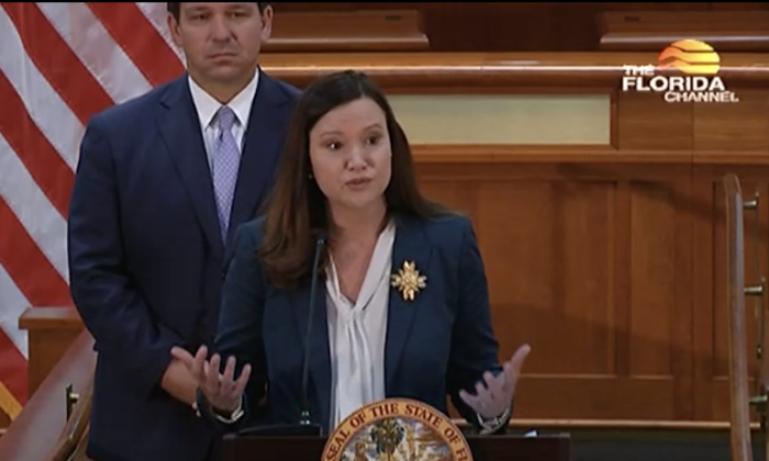 Florida Attorney General Ashley Moody speaks at a press conference at the Florida Capitol in Tallahassee March 29, as Fla. Gov. Ron DeSantis looks on. (The Florida Channel)