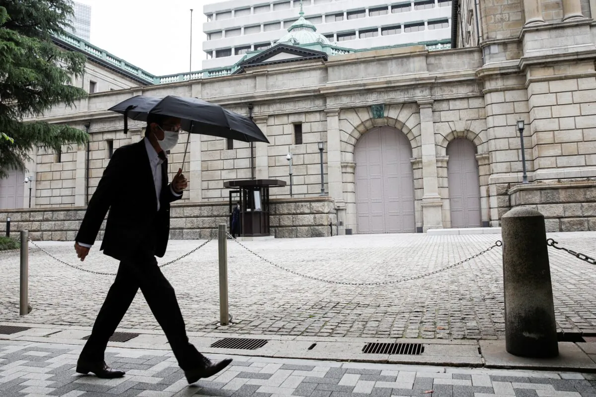 A man wearing a protective mask walks past the headquarters of Bank of Japan in Tokyo, on May 22, 2020. (Kim Kyung-Hoon/Reuters)