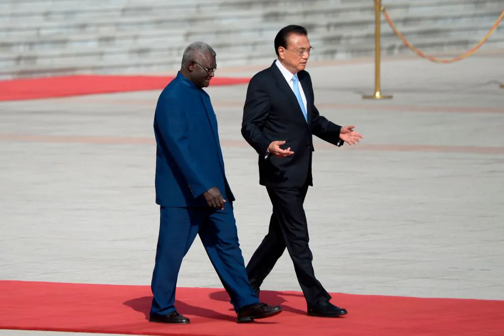 Solomon Islands Prime Minister Manasseh Sogavare (L) talks with Chinese Premier Li Keqiang as they prepare to inspect honour guards during a welcome ceremony at the Great Hall of the People in Beijing on Oct 9, 2019 in Beijing, China. (Wang Zhao/AFP via Getty Images)