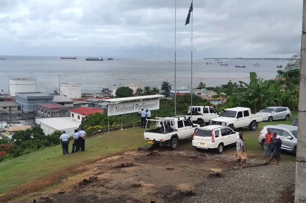 Police stand guard outside Parliament in Honiara, Guadalcanal Island in the Solomon Islands, on Dec. 6, 2021 (Mavis Podokolo/AFP via Getty Images)