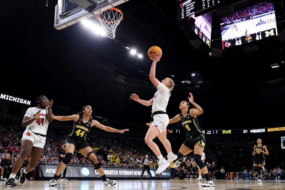 Hailey Van Lith #10 of the Louisville Cardinals drives to the basket against Laila Phelia #5 of the Michigan Wolverines during the second half in the Elite Eight round game of the 2022 NCAA Women's Basketball Tournament at Intrust Bank Arena, in Wichita, Kansas, on March 28, 2022. (Andy Lyons/Getty Images)