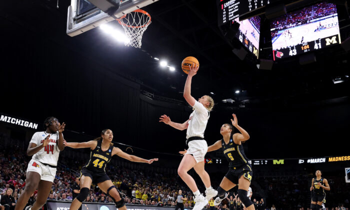 Hailey Van Lith #10 of the Louisville Cardinals drives to the basket against Laila Phelia #5 of the Michigan Wolverines during the second half in the Elite Eight round game of the 2022 NCAA Women's Basketball Tournament at Intrust Bank Arena, in Wichita, Kansas, on March 28, 2022. (Andy Lyons/Getty Images)