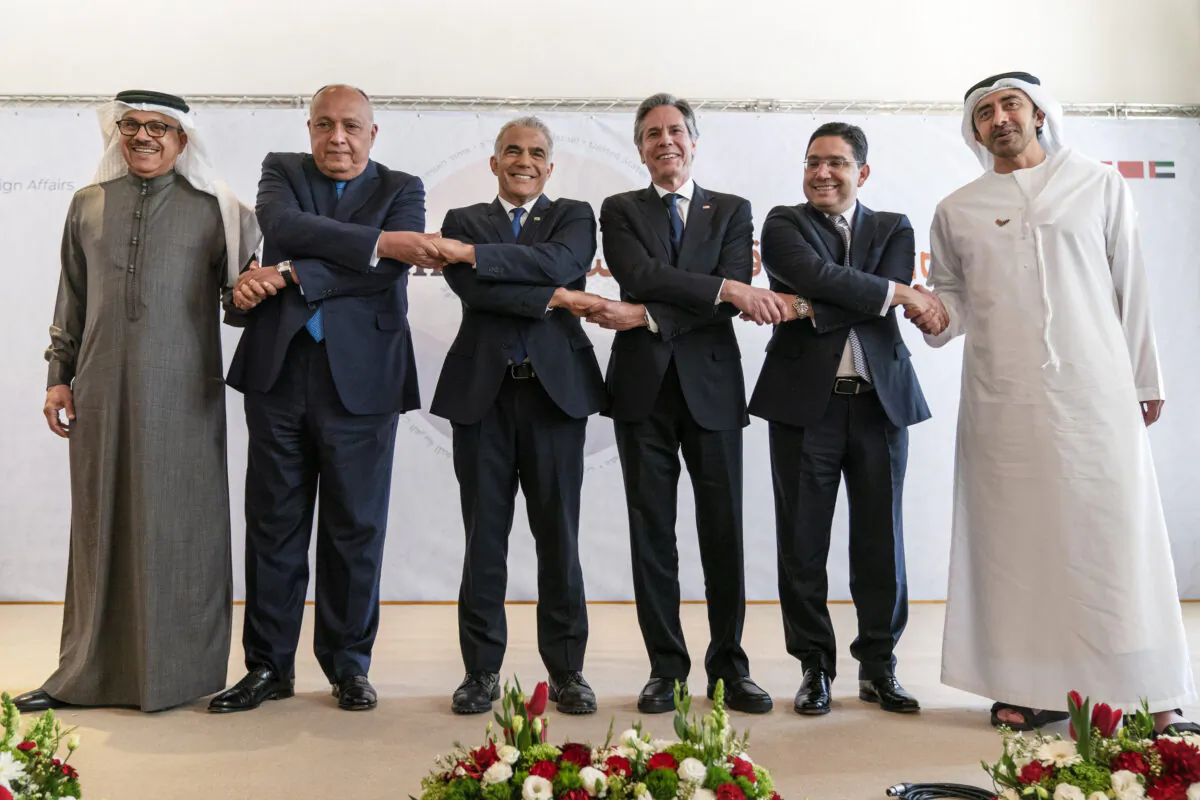 (L–R) After meeting for the Negev Summit, Bahrain’s Foreign Minister Abdullatif bin Rashid al-Zayani, Egypt’s Foreign Minister Sameh Shoukry, Israel’s Foreign Minister Yair Lapid, U.S. Secretary of State Antony Blinken, Morocco’s Foreign Minister Nasser Bourita, and United Arab Emirates’ Foreign Minister Sheikh Abdullah bin Zayed Al Nahyan, pose for a photograph in Sde Boker, Israel, on March 28, 2022. (Jacquelyn Martin/Pool  via AP)