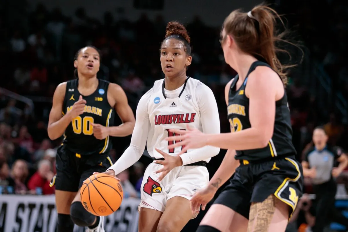 Louisville Cardinals guard Kianna Smith (14) drives to the basket against the Michigan Wolverines in the Wichita regional finals of the women's college basketball NCAA Tournament at INTRUST Bank Arena in Wichita, Kan., on March 28, 2022. (William Purnell/USA TODAY Sports via Field Level Media)