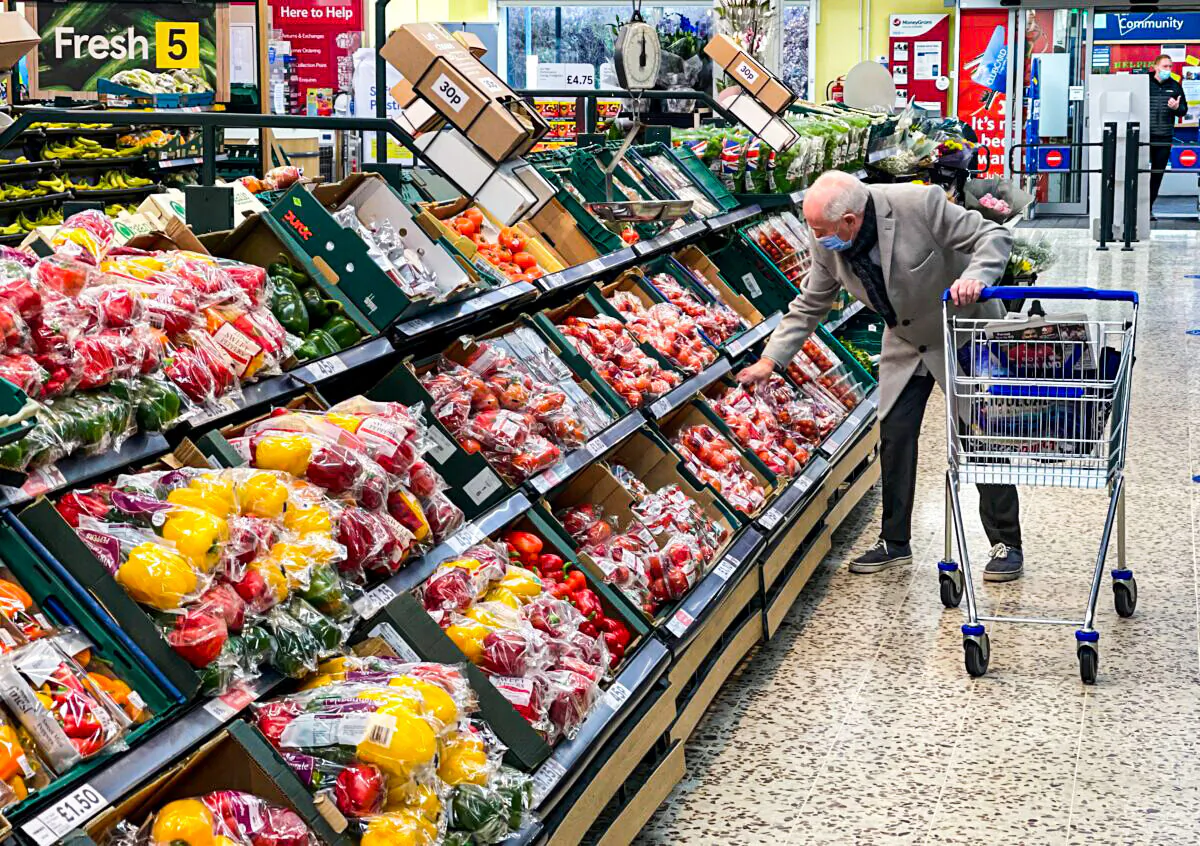 A customer shops for food items inside a Tesco supermarket store in east London, on Jan. 10, 2022. (Daniel Leal/AFP via Getty Images)
