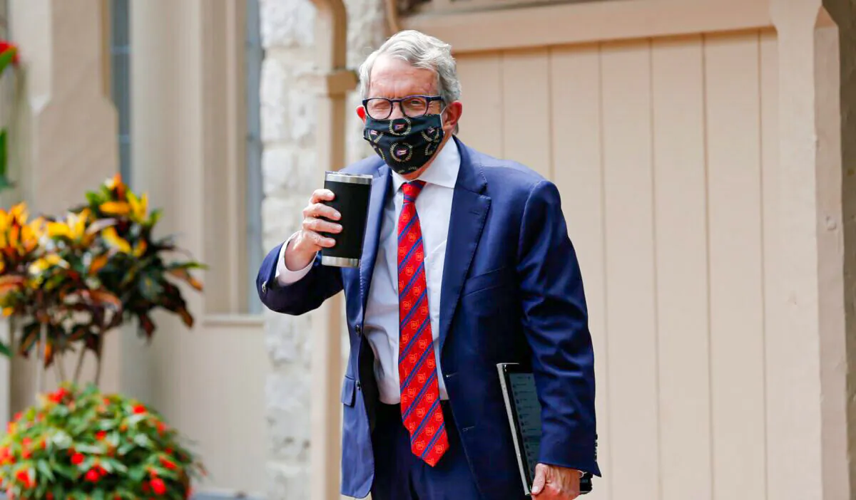 Ohio Gov. Mike DeWine acknowledges members of the media while entering his residence in Bexley, Ohio, on Aug. 6, 2020. (Jay LaPrete/AP photo)