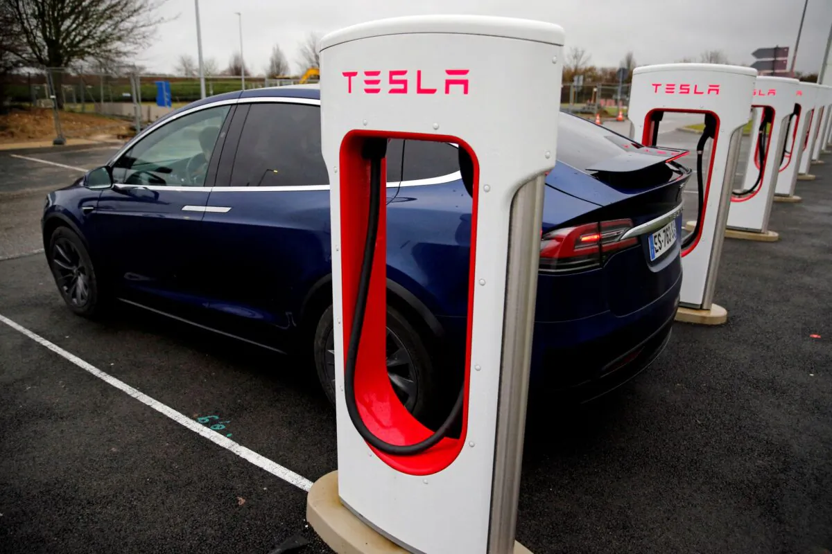 A driver recharges the battery of his Tesla car at a Tesla Super Charging station in a petrol station on the highway in Sailly-Flibeaucourt, France, on Jan. 12, 2019. (Pascal Rossignol/File Photo/Reuters)