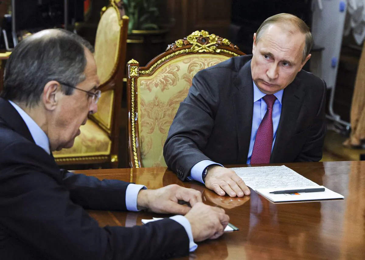 Russian President Vladimir Putin, right, listens to Russian Foreign Minister Sergey Lavrov in a file photo. (Mikhail Klimentyev/Sputnik, Kremlin Pool Photo via AP)
