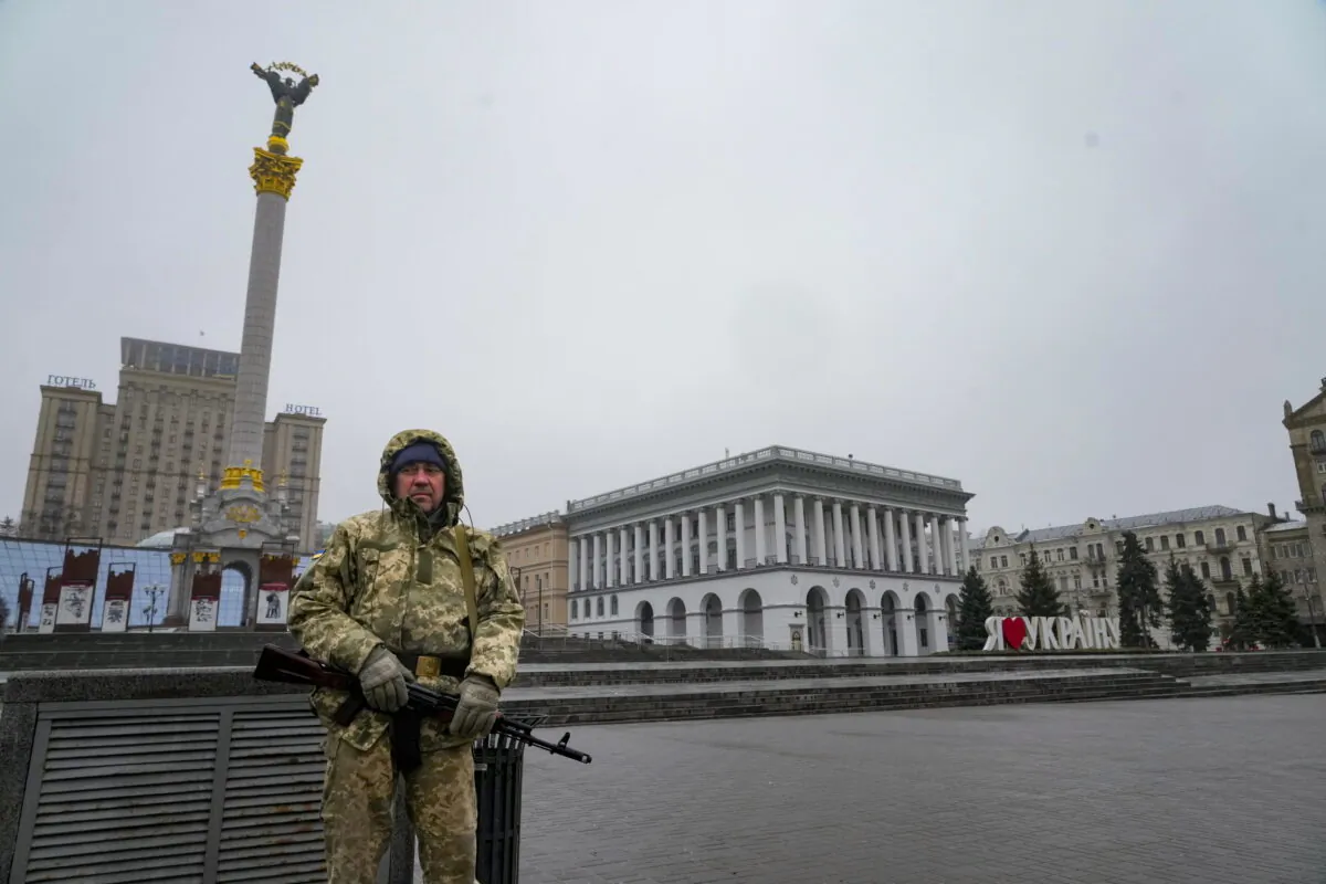 An armed man stands at the Independent Square (Maidan) in the center of Kyiv, Ukraine, on March 2, 2022. (AP Photo/Efrem Lukatsky)