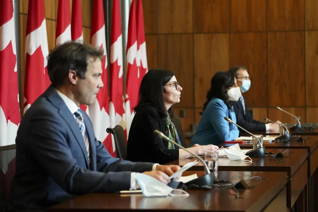 Filomena Tassi (C), minister of public services and procurement, along with Anita Anand (2nd R), minister of national defence, and representatives from the federal government hold a press conference in Ottawa on March 28, 2022. (Sean Kilpatrick/The Canadian Press)