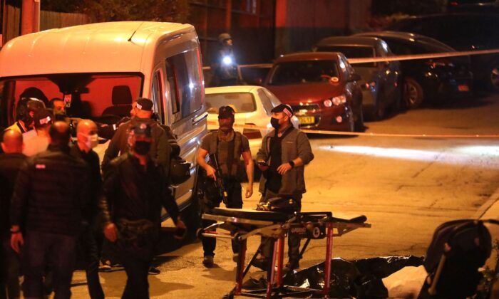 Israeli security forces and emergency personnel gather at the scene of a shooting attack in Bnei Brak, 7km (4.5 miles) east of Tel Aviv, on March 29, 2022. (Gill Cohen-Magen/AFP via Getty Images)