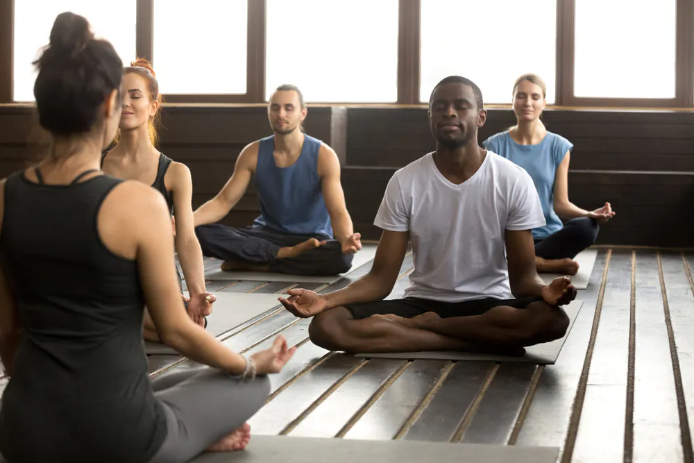A group of people is seen practicing meditation in a file photo. (Shutterstock)