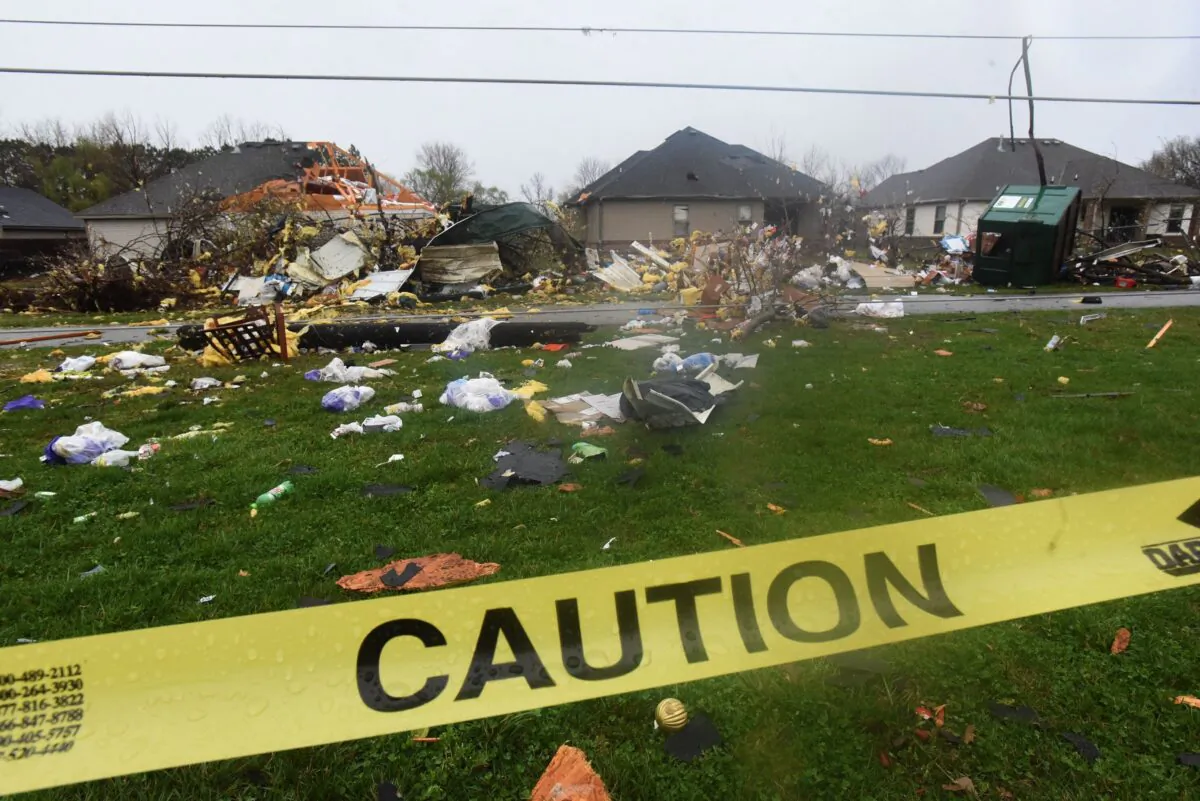 Debris litters a neighborhood one block west of Powell Street near Don Tyson Parkway in Springdale, Ark., on March 30, 2022. (Flip Putthoff/The Northwest Arkansas Democrat-Gazette via AP)
