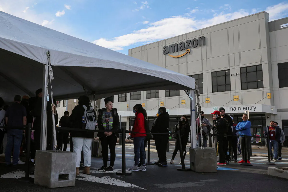 Workers stand in line to cast ballots for a union election at Amazon's JFK8 distribution center, in the Staten Island borough of New York City, on March 25, 2022. (Brendan McDermid/Reuters)