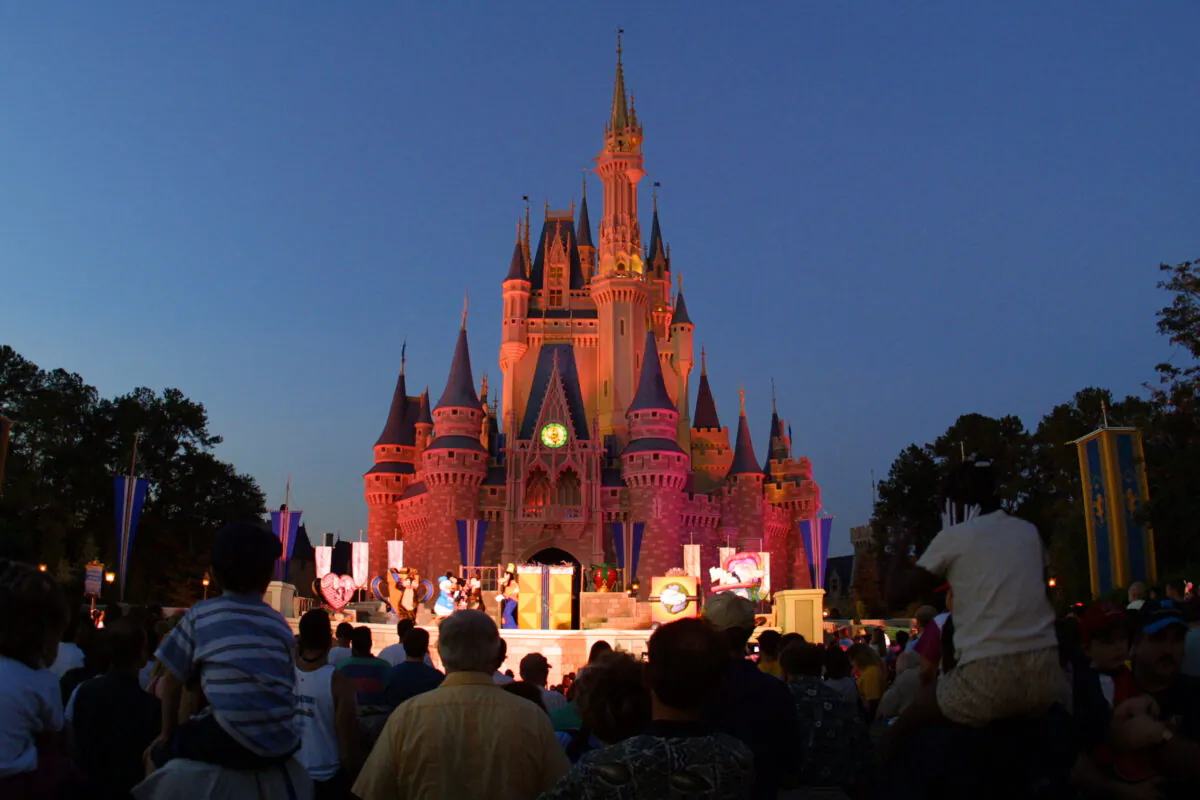 Park patrons watch a show in front of Cinderella Castle at Walt Disney World's Magic Kingdom in Orlando, Fla., in this file photo. (Joe Raedle/Getty Images)