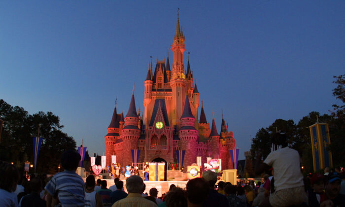 People watch a show on stage in front of Cinderella's castle at Walt Disney World's Magic Kingdom in Orlando, Fla., in this file photo. (Joe Raedle/Getty Images)