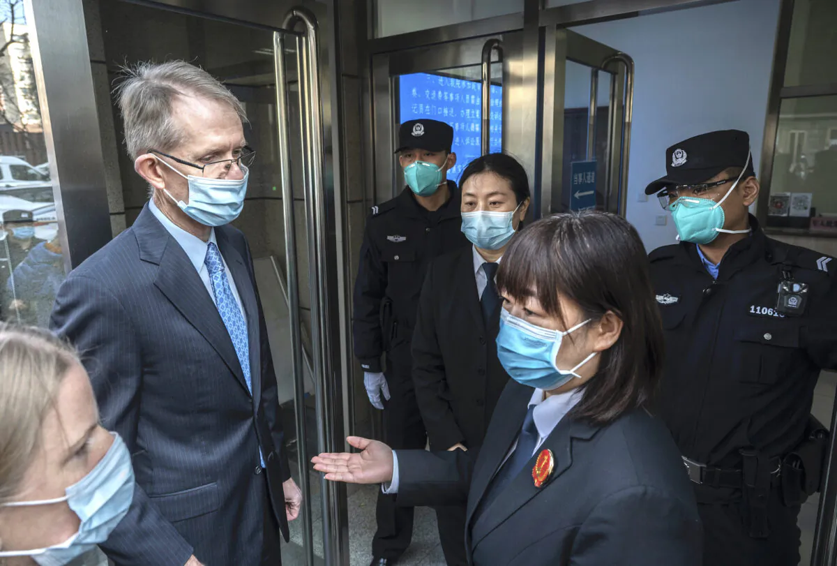 Australian Ambassador to China Graham Fletcher (left) is turned away by court officials and police as he tries to enter the trial of Chinese Australian journalist Cheng Lei at the Beijing Number 2 Intermediate People’s Court in Beijing on March 31, 2022. (Kevin Frayer/Getty Images)